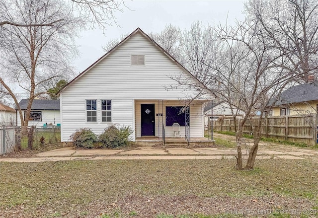 view of front of property with fence and covered porch