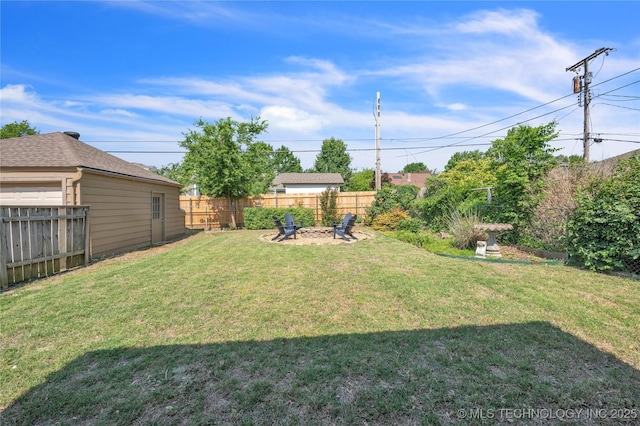 view of yard with a fire pit and a fenced backyard