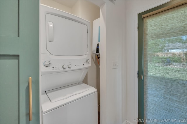 washroom featuring laundry area and stacked washing maching and dryer