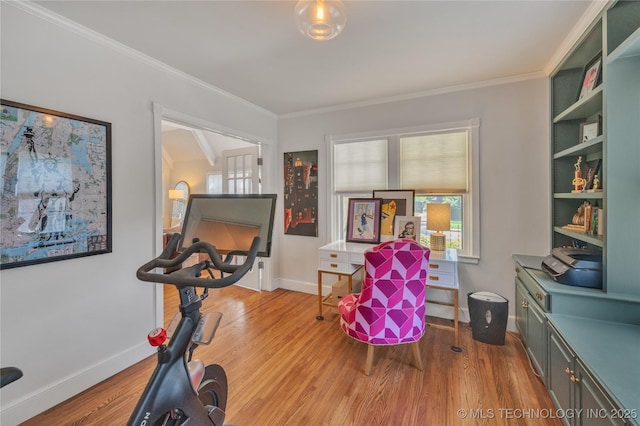 exercise area with wood finished floors and crown molding