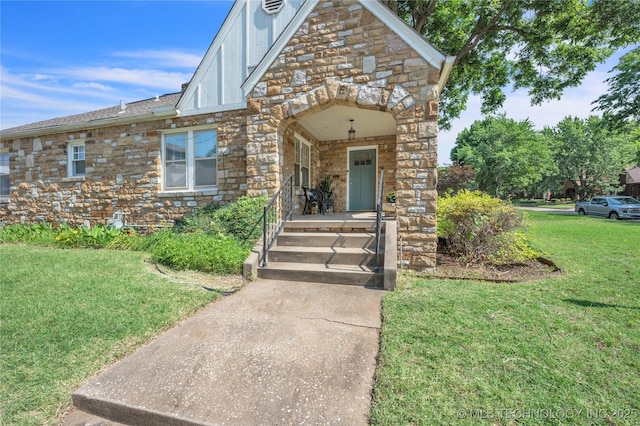 view of front facade with stone siding and a front yard