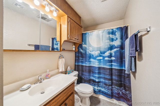 bathroom with visible vents, a textured ceiling, and vanity