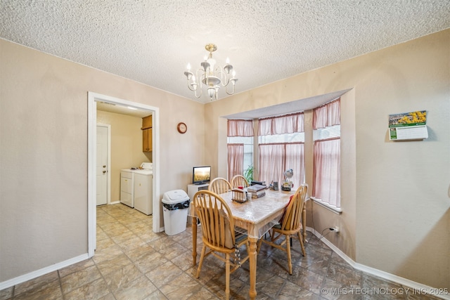 dining room with baseboards, a textured ceiling, a chandelier, and washing machine and clothes dryer