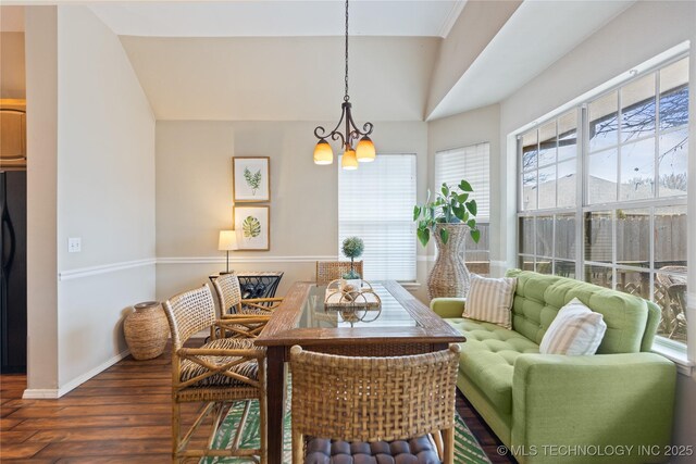 dining room with a chandelier, baseboards, a healthy amount of sunlight, and wood finished floors