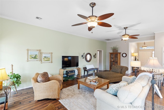 living room featuring visible vents, wood finished floors, and crown molding