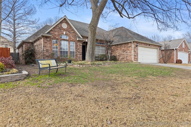 ranch-style house featuring brick siding, fence, a front yard, a garage, and driveway