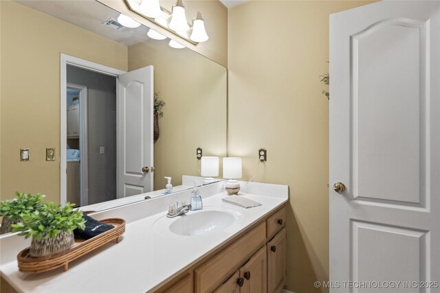 bathroom with visible vents and vanity