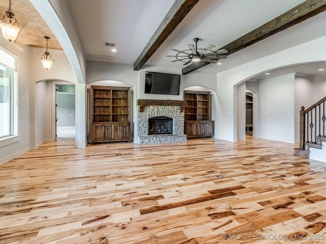 12491 S 105th Ave E, Bixby, OK 74008 - unfurnished living room with a ceiling fan, light wood-type flooring, beam ceiling, stairway, and baseboards