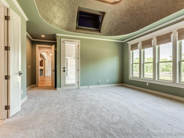 12491 S 105th Ave E, Bixby, OK 74008 - carpeted empty room featuring arched walkways, crown molding, and baseboards