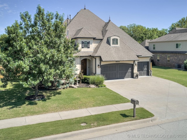12491 S 105th Ave E, Bixby, OK 74008 - french country inspired facade with stucco siding, concrete driveway, a shingled roof, a garage, and a front lawn
