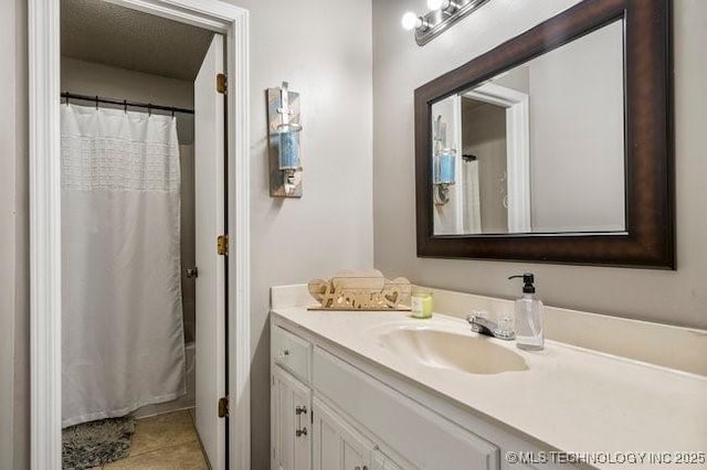 bathroom featuring vanity, a shower with shower curtain, and tile patterned floors