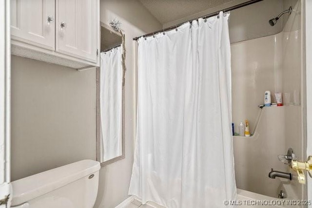 bathroom with toilet and a shower with curtain