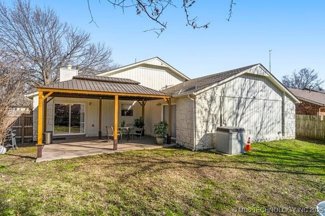 back of house with a patio, central AC unit, fence, a yard, and a chimney