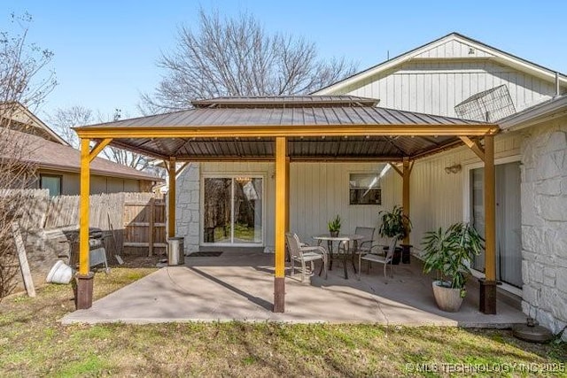 view of patio / terrace featuring a gazebo and fence