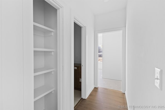 corridor with wood finished floors