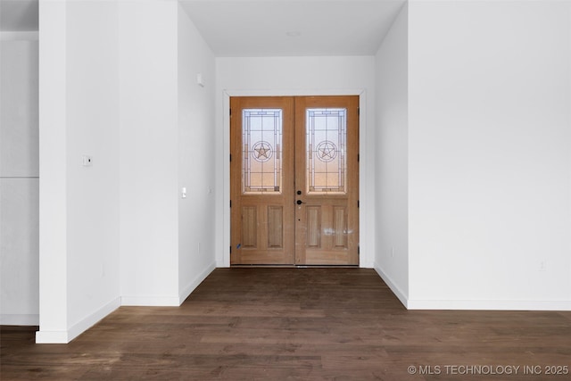 foyer featuring dark wood-style floors, french doors, and baseboards