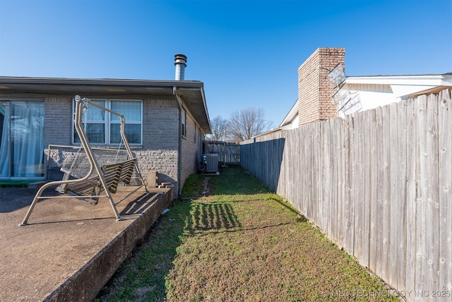 view of yard with cooling unit and fence