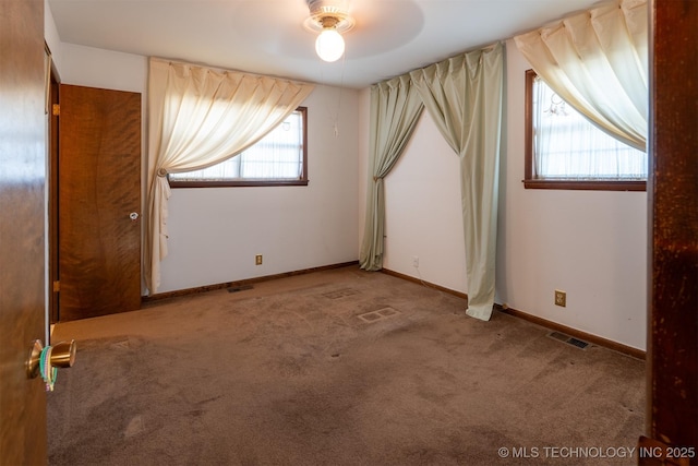 unfurnished bedroom with visible vents, baseboards, a ceiling fan, and carpet flooring