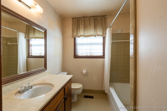 bathroom with tile patterned flooring, toilet, a healthy amount of sunlight, and visible vents