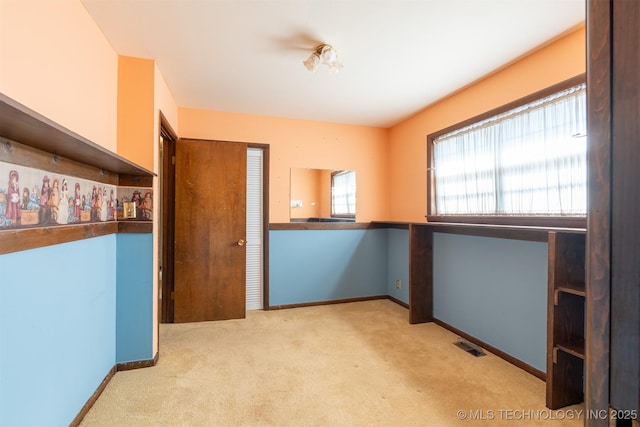 interior space with visible vents, baseboards, a closet, and carpet flooring