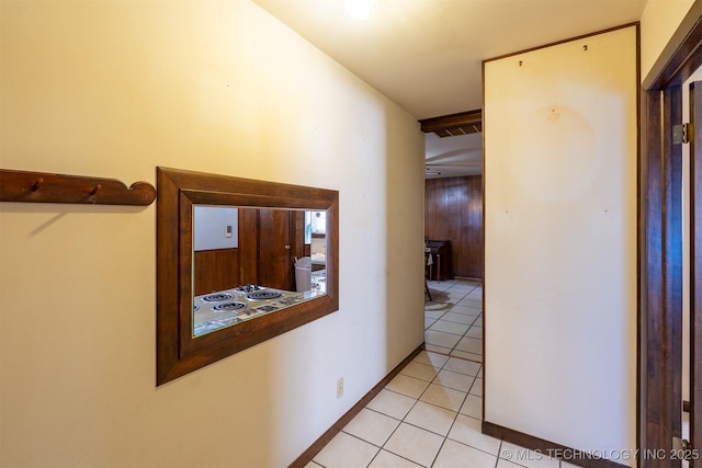 hallway featuring light tile patterned floors and visible vents