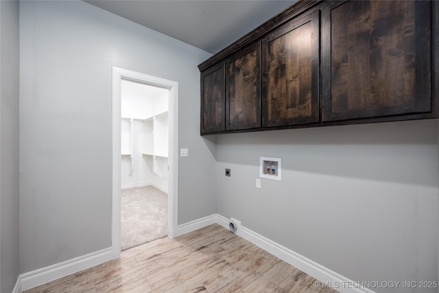 washroom featuring baseboards, washer hookup, light wood-style floors, cabinet space, and electric dryer hookup