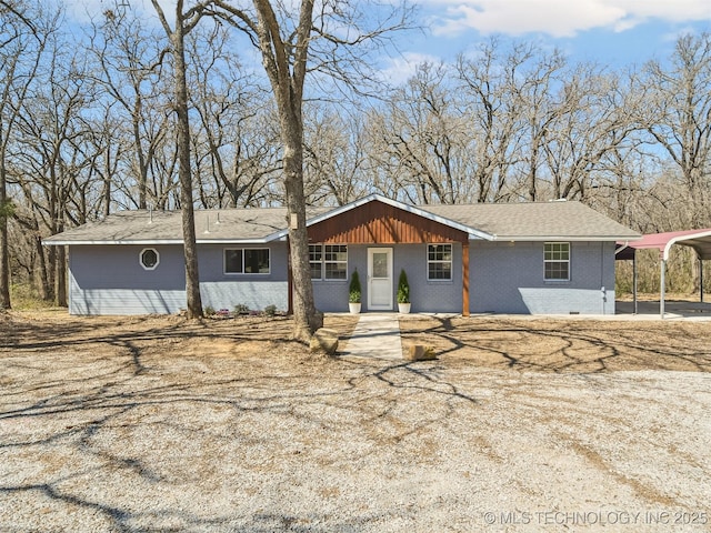 ranch-style home with brick siding and a carport