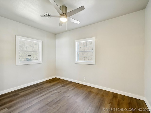 spare room featuring plenty of natural light, baseboards, and ceiling fan