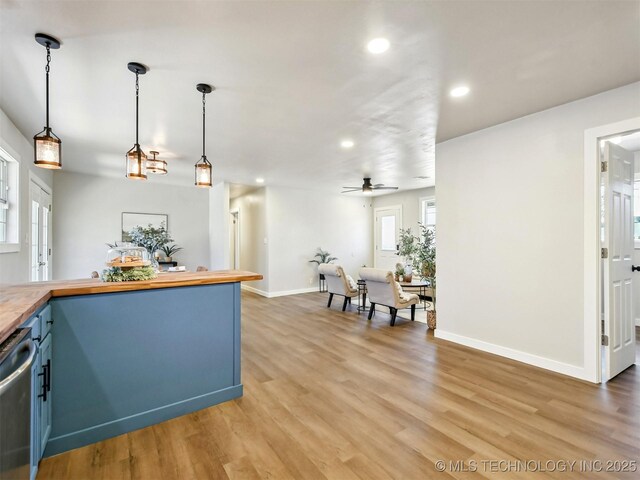 kitchen featuring blue cabinetry, recessed lighting, butcher block countertops, dishwasher, and light wood-type flooring