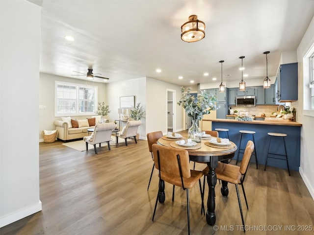 dining area featuring recessed lighting, ceiling fan, baseboards, and wood finished floors