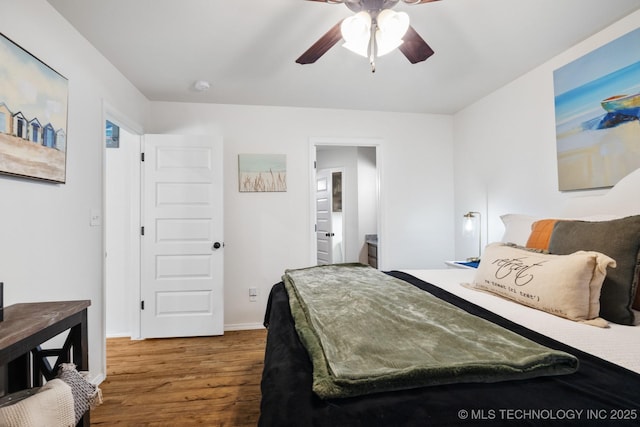 bedroom featuring a ceiling fan, wood finished floors, and baseboards