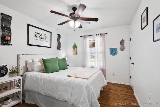 bedroom featuring ceiling fan, visible vents, baseboards, and wood finished floors