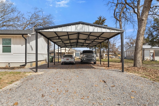 view of parking / parking lot featuring a detached carport and gravel driveway