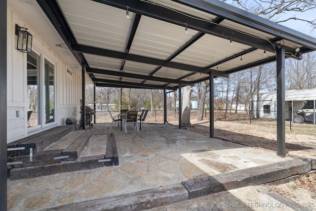 view of patio with a carport, fence, and grilling area