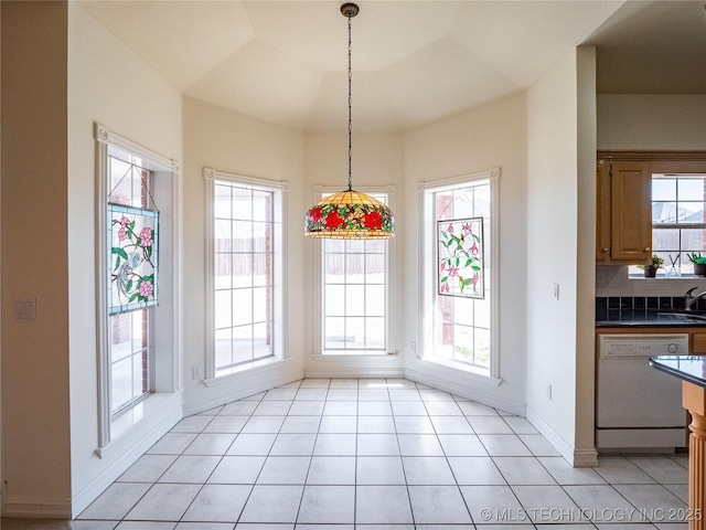 dining room with light tile patterned flooring and baseboards