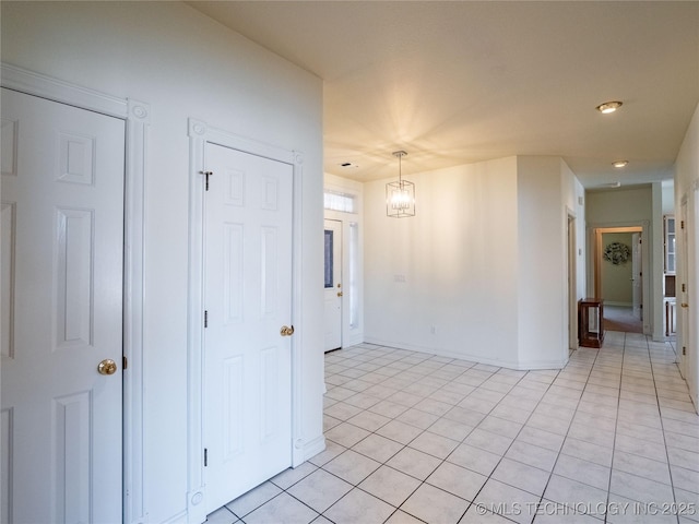 spare room with light tile patterned flooring and baseboards