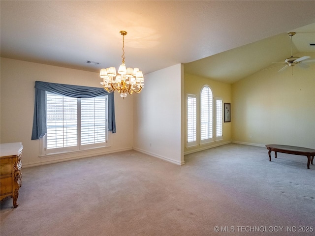 spare room with ceiling fan with notable chandelier, vaulted ceiling, carpet, and visible vents