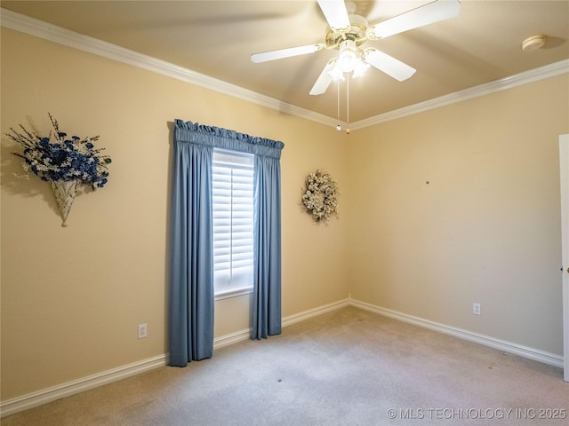 empty room with baseboards, carpet floors, and crown molding