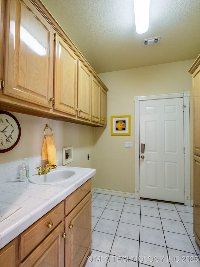 laundry area with visible vents, hookup for an electric dryer, cabinet space, a sink, and washer hookup