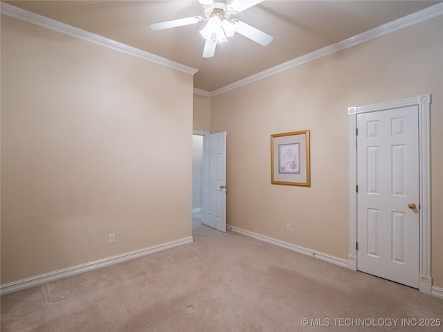 unfurnished room with a ceiling fan, light colored carpet, baseboards, and ornamental molding