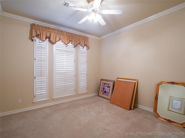 spare room featuring carpet flooring, a ceiling fan, and ornamental molding