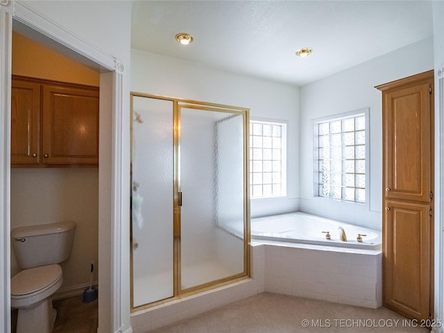 bathroom with a stall shower, toilet, and a bath