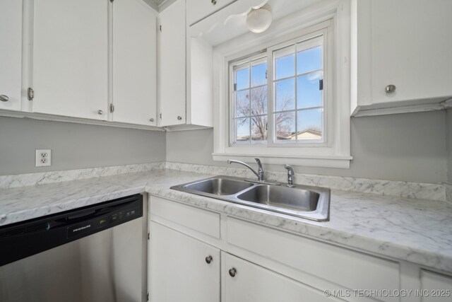 8930 E Marshall St, Tulsa, OK 74115 - kitchen featuring stainless steel dishwasher, light countertops, white cabinetry, and a sink