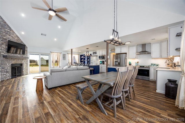 1522 Burney Cemetary, Calera, OK 74730 - dining space with high vaulted ceiling, a large fireplace, ceiling fan, recessed lighting, and dark wood-style floors