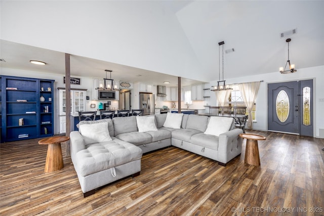 1522 Burney Cemetary, Calera, OK 74730 - living room with visible vents, high vaulted ceiling, dark wood-type flooring, and a chandelier