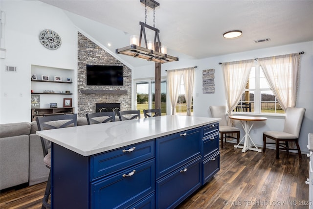 1522 Burney Cemetary, Calera, OK 74730 - kitchen with dark wood finished floors, open floor plan, visible vents, and blue cabinetry