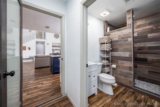 1522 Burney Cemetary, Calera, OK 74730 - bathroom featuring toilet, vanity, tiled shower, and wood finished floors