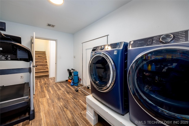 1522 Burney Cemetary, Calera, OK 74730 - washroom featuring visible vents, wood finished floors, washing machine and clothes dryer, and laundry area