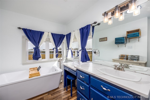 1522 Burney Cemetary, Calera, OK 74730 - bathroom with a freestanding bath, vanity, and wood finished floors