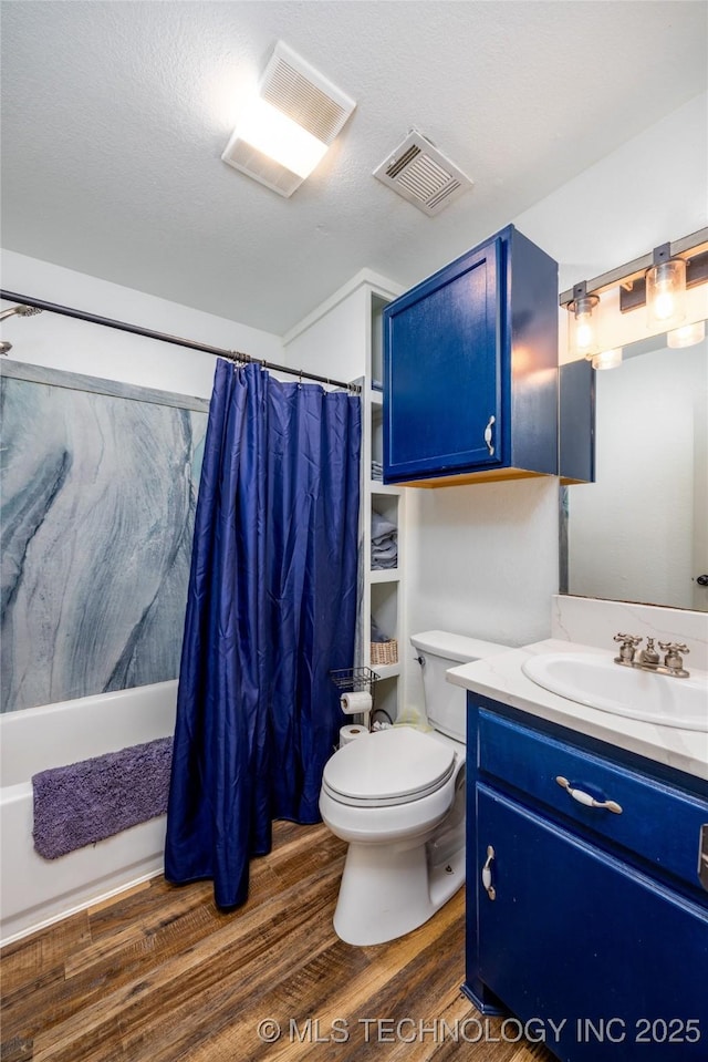 1522 Burney Cemetary, Calera, OK 74730 - full bathroom with vanity, toilet, a textured ceiling, visible vents, and wood finished floors
